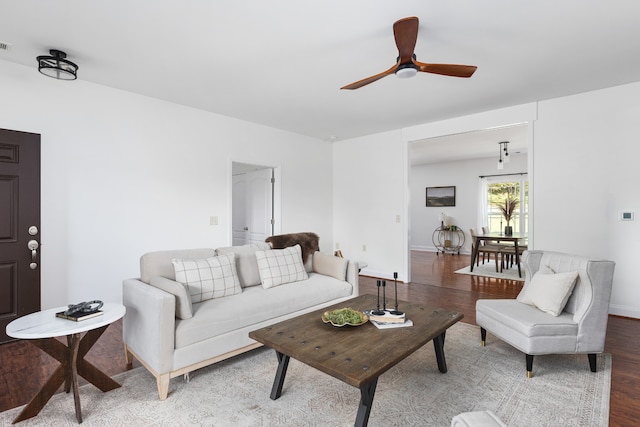 living room featuring ceiling fan and hardwood / wood-style floors