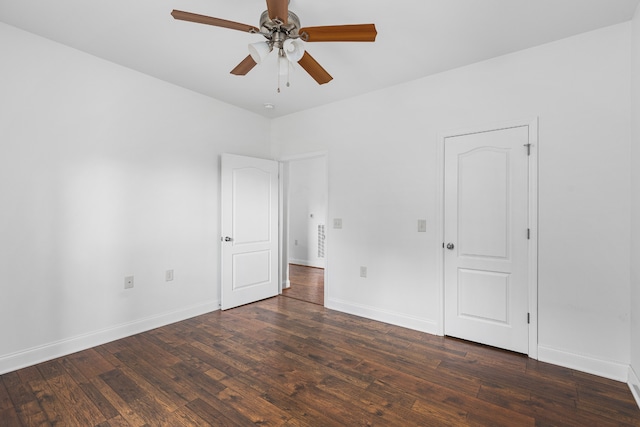 spare room with ceiling fan and dark hardwood / wood-style floors