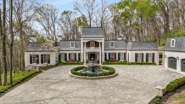 view of front of house featuring a balcony and a garage