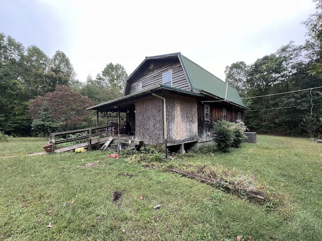 view of side of home with a yard and central AC