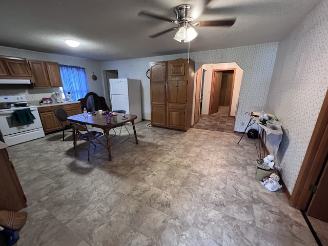 kitchen featuring a textured ceiling, white appliances, ceiling fan, and ventilation hood