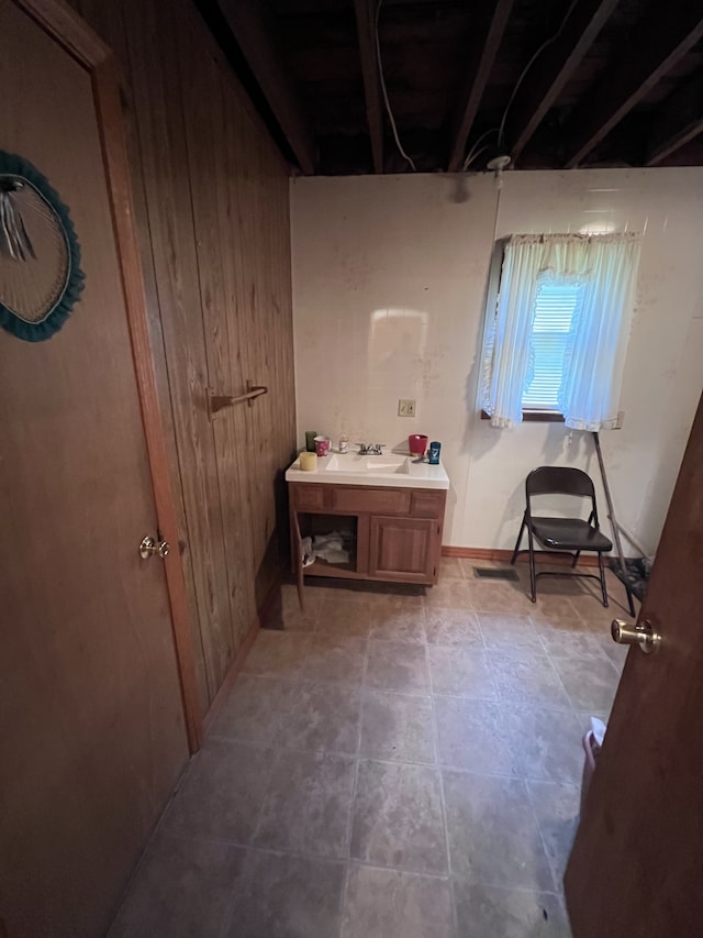 bathroom featuring wooden walls