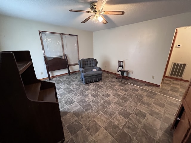 living area featuring ceiling fan