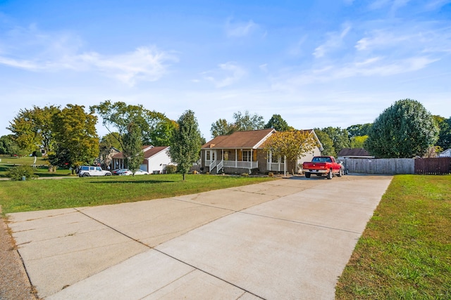 ranch-style home with covered porch and a front yard