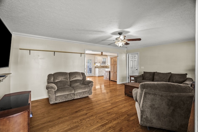 living room featuring ceiling fan, a textured ceiling, and dark hardwood / wood-style flooring