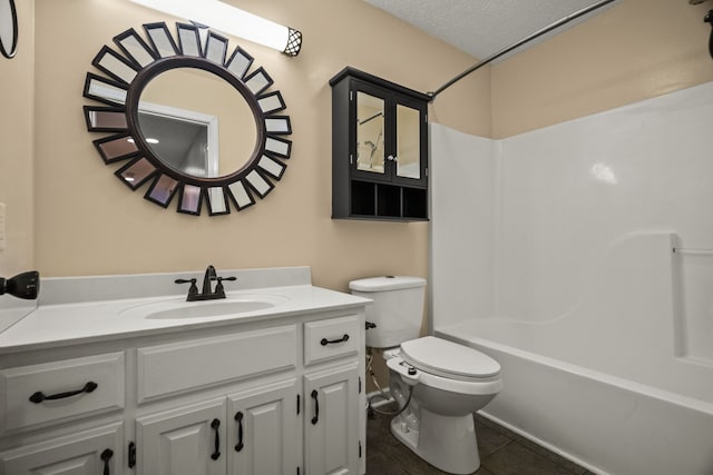 full bathroom with tile patterned floors, a textured ceiling, toilet, vanity, and bathing tub / shower combination