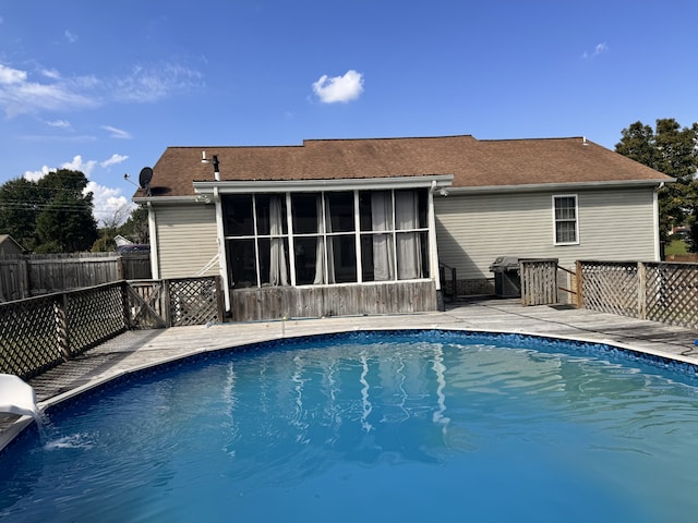 view of pool with a sunroom