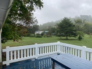 wooden deck with a lawn