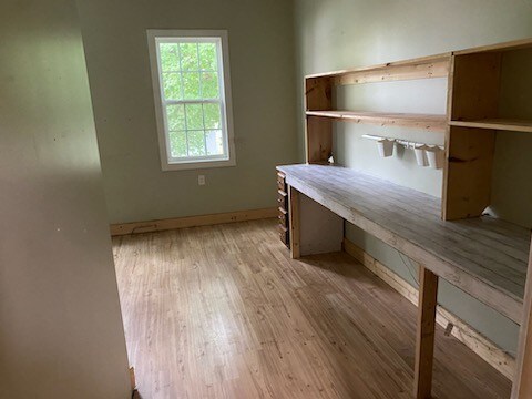 unfurnished office with light wood-type flooring