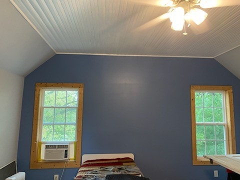 bedroom featuring ceiling fan, cooling unit, and vaulted ceiling