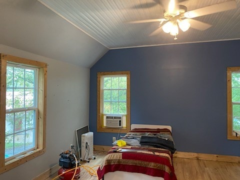 bedroom with vaulted ceiling, ceiling fan, and hardwood / wood-style flooring