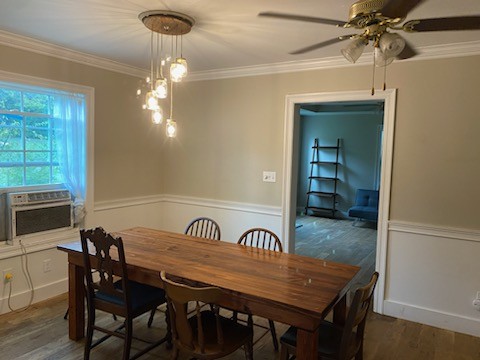 dining room featuring ceiling fan, ornamental molding, and dark hardwood / wood-style flooring