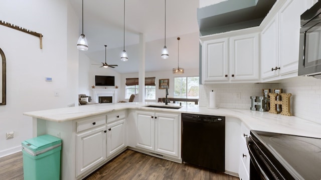 kitchen featuring white cabinets, decorative light fixtures, sink, and black appliances