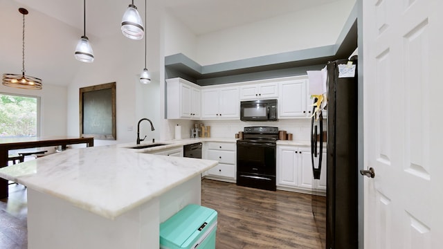 kitchen with white cabinets, hanging light fixtures, sink, kitchen peninsula, and black appliances