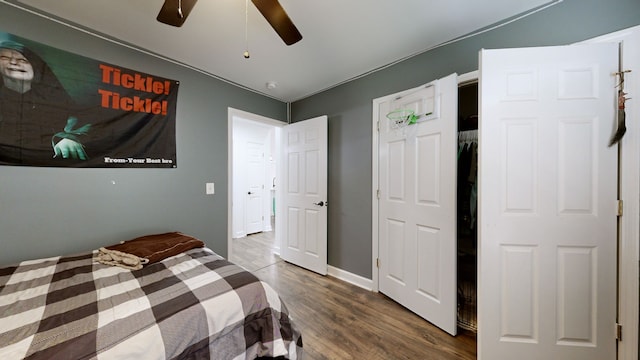 bedroom with ceiling fan and dark hardwood / wood-style flooring