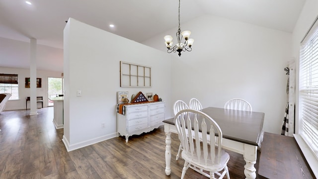 dining space with an inviting chandelier, lofted ceiling, and dark hardwood / wood-style floors