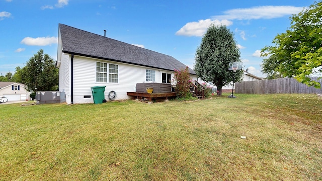 rear view of property with a lawn and a deck