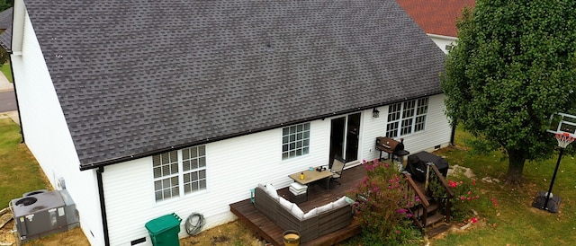 back of property with a wooden deck and central AC