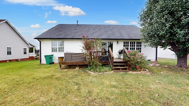 rear view of house featuring a lawn and a wooden deck