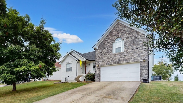 view of property with central AC, a front yard, and a garage