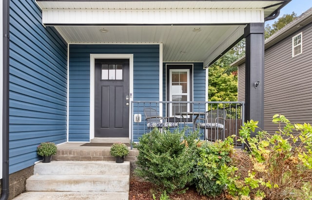 view of exterior entry featuring covered porch