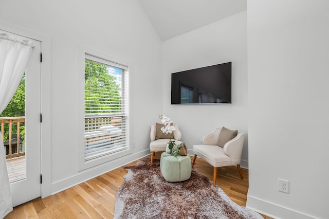 sitting room with vaulted ceiling and hardwood / wood-style flooring