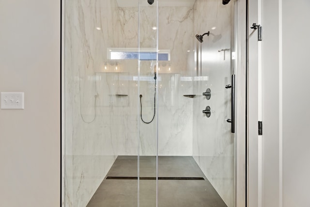 bathroom featuring a shower with door