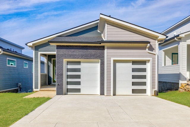 view of front facade with a garage and a front lawn