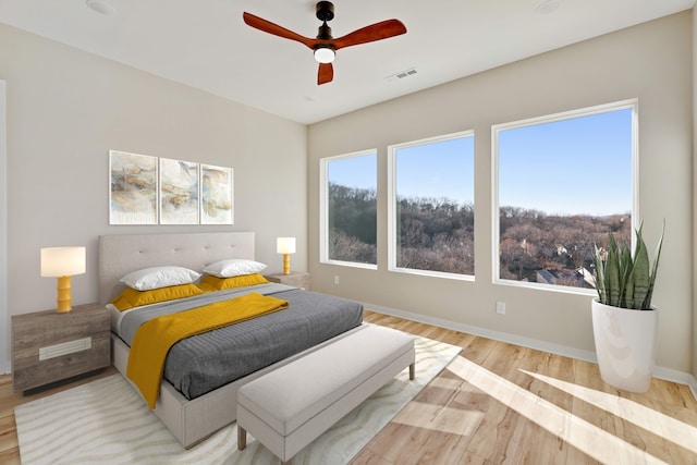 bedroom with light hardwood / wood-style floors and ceiling fan