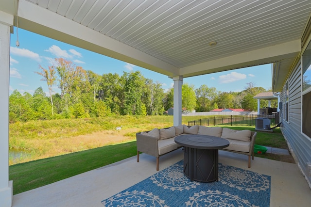 view of patio featuring an outdoor fire pit and central AC unit