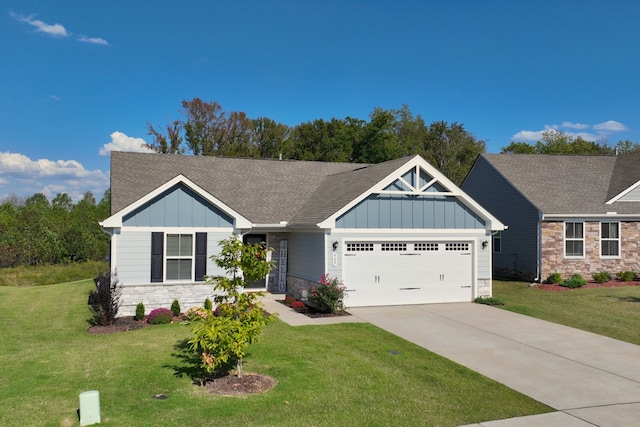 craftsman inspired home featuring a garage and a front lawn