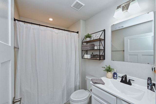 bathroom featuring vanity, toilet, and a shower with curtain