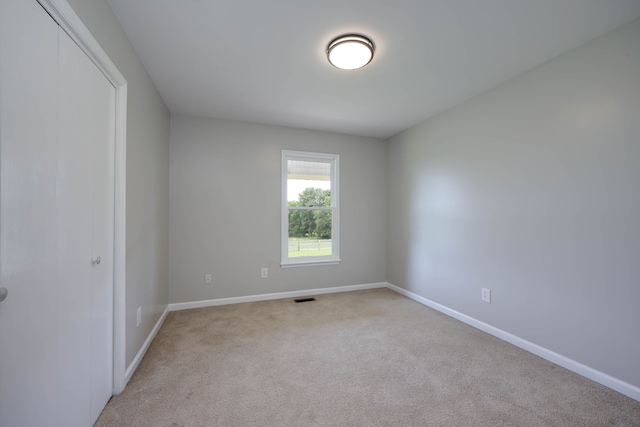 empty room featuring light colored carpet