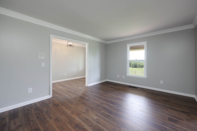 empty room featuring crown molding and dark hardwood / wood-style floors