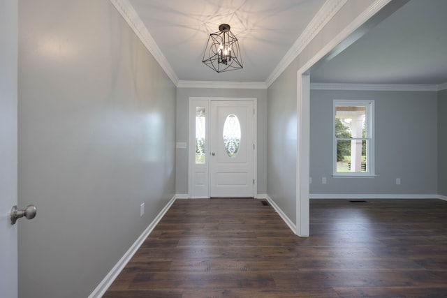 foyer with dark hardwood / wood-style floors, crown molding, and a notable chandelier