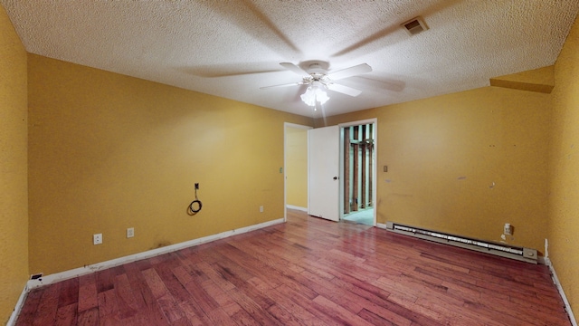 empty room with a baseboard radiator, wood-type flooring, a textured ceiling, and ceiling fan