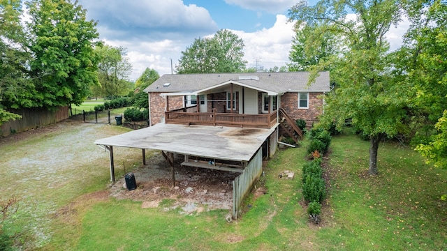 rear view of property with a wooden deck