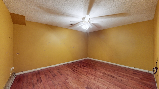 empty room featuring ceiling fan, a textured ceiling, and hardwood / wood-style floors