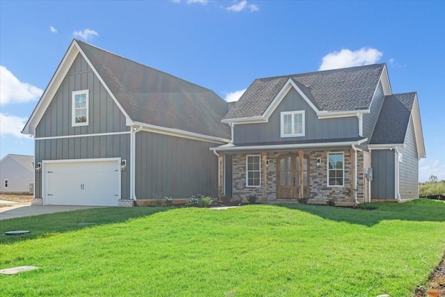 craftsman house with a front yard and a garage