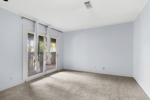 carpeted empty room featuring crown molding