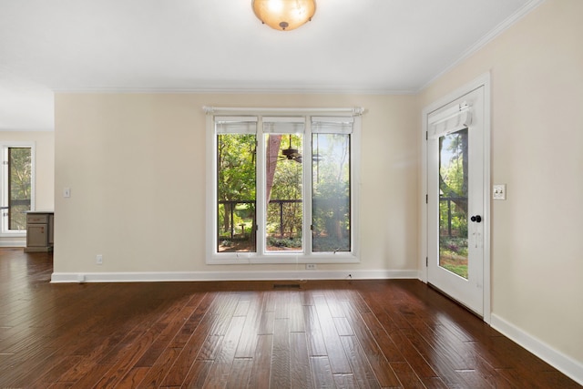 unfurnished room with dark wood-type flooring, ornamental molding, and a healthy amount of sunlight