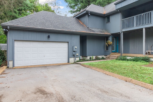 view of property with a garage and a front lawn