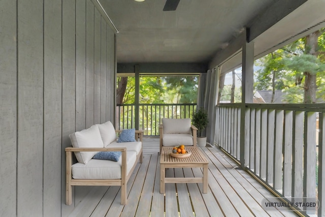 sunroom / solarium featuring ceiling fan