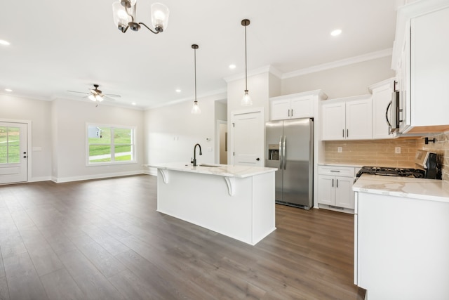 kitchen featuring appliances with stainless steel finishes, white cabinetry, and a wealth of natural light