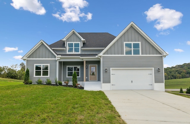 craftsman-style house featuring a garage and a front yard