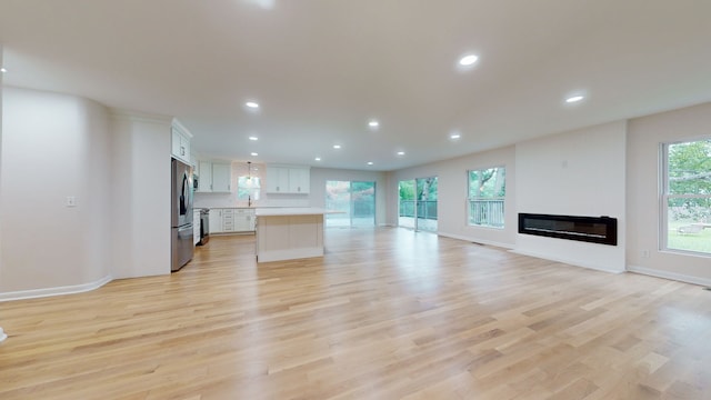 unfurnished living room with light hardwood / wood-style flooring