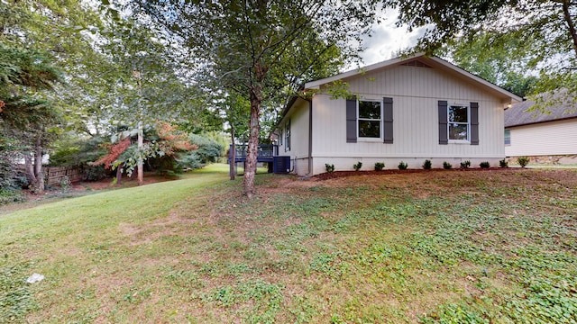 view of property exterior with cooling unit and a lawn