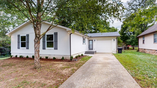 view of front of house featuring a front yard and a garage