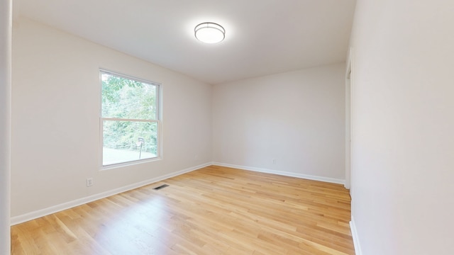 spare room featuring light wood-type flooring