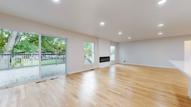 unfurnished living room featuring light wood-type flooring